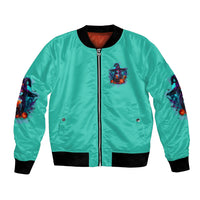 Turquoise zip-up bomber jacket with chest patch, black ribbed cuffs, and sleeve witch art