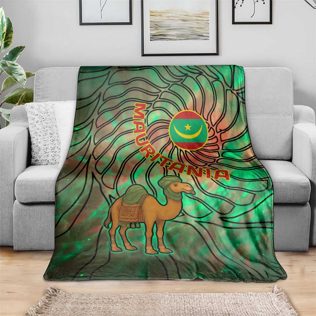 Green tie-dye throw blanket draped on couch with camel and Mauritania crescent emblem