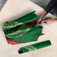 Close-up of Guinea-Bissau umbrella fabric with green panels and laurel star graphics