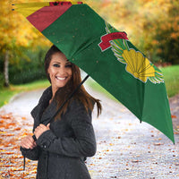 Open Guinea-Bissau umbrella with green side panel and laurel flower graphic near edge
