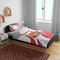 Red, white, and gray Singapore crest bedding set on bed with coordinated pillow