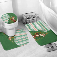 Green and white holiday bathroom mat set with Santa figure for toilet and floor