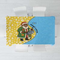 Blue and yellow Christmas tablecloth with Santa and steelpan graphic, floral accents