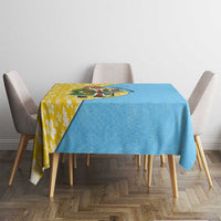 Blue and yellow Christmas tablecloth with Santa graphic, draped on dining table