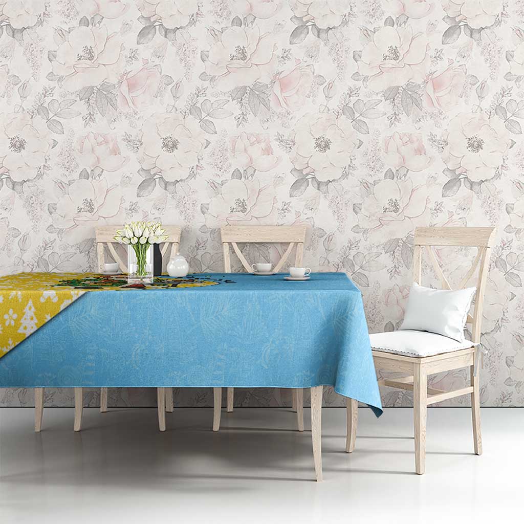 Blue Christmas tablecloth with subtle leaf pattern on rectangular dining table