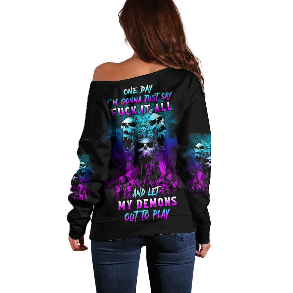 Off-shoulder black sweater with purple/blue demon graphic and back text