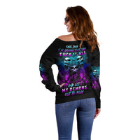 Off-shoulder black sweater with large back demon graphic and purple/blue lettering