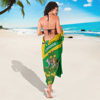 Comoros sarong worn as wrap, green with yellow panel, lemur and botanical print
