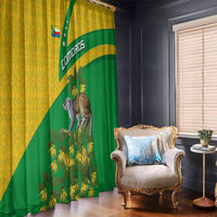 Green and yellow window curtain with Comoros flag stripe, lemur, and ylang-ylang flowers
