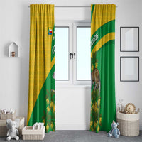 Two long window curtains, yellow-green with Comoros flag diagonal and lemur pattern