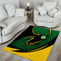 Green and yellow area rug with black swirl and circular emblem center