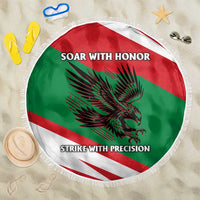 Round Oman-themed beach blanket with flag colors, falcon graphic, fringe edge, text