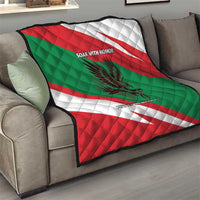 Oman quilt with red/green/white diagonal stripes, quilted pattern, falcon graphic and slogan text