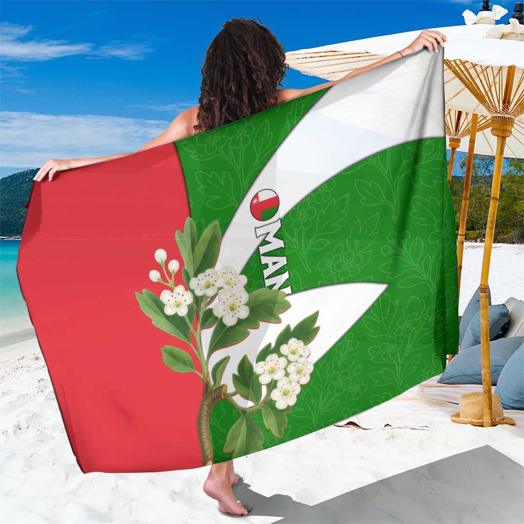 Oman sarong with green and red flag design, white floral blossoms, draped