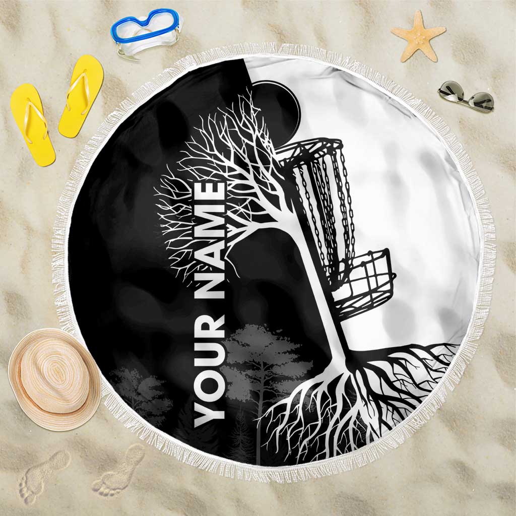 Black and white round beach blanket with tree and roots graphic, fringe edge