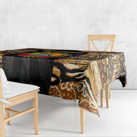 Close-up tribal tablecloth over bench table with black, tan, and brown motif panel