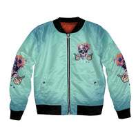 Light teal bomber jacket with zip front, skull logo and floral sleeve graphics