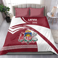 Red and white duvet and matching pillows with Latvia text, flag stripe design, coat of arms