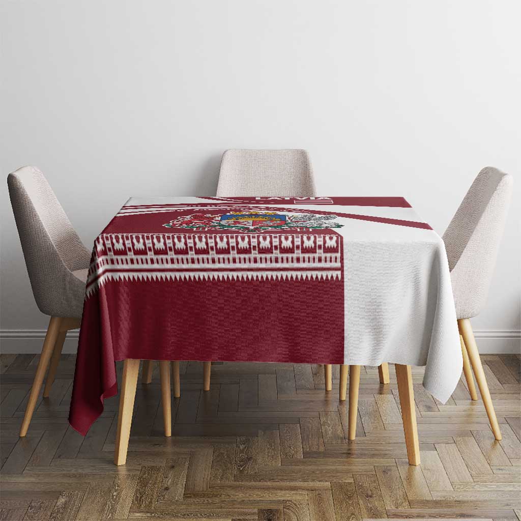 Red and white Latvia tablecloth with folk pattern band and emblem on square dining table