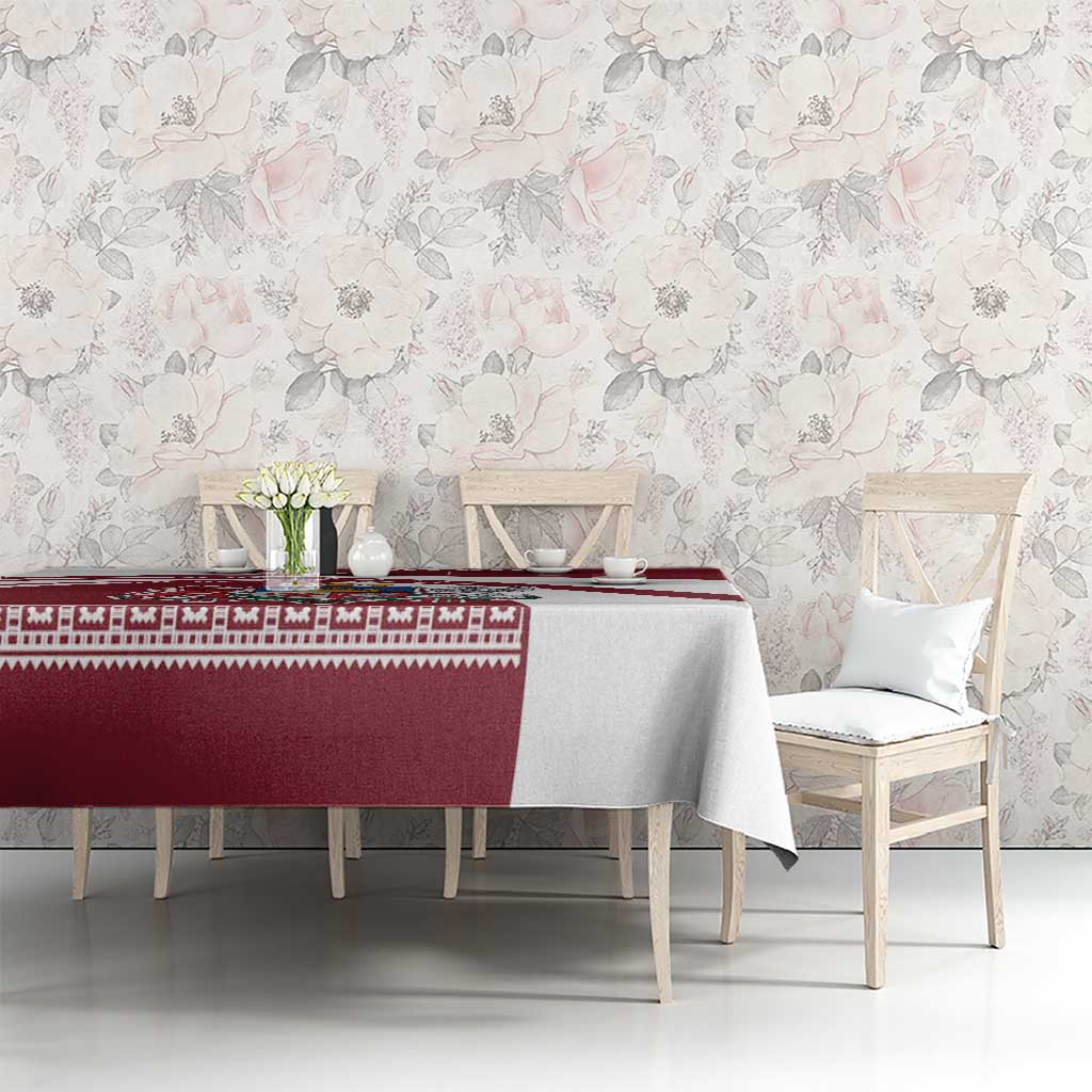 Red and white Latvia tablecloth with patterned band across the center on dining table