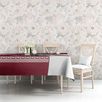 Red and white Latvia tablecloth with patterned band across the center on dining table
