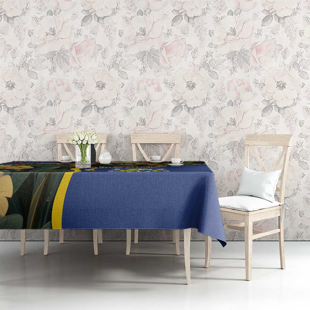 Blue tablecloth with jungle animal artwork and Central African Republic emblem on dining table.