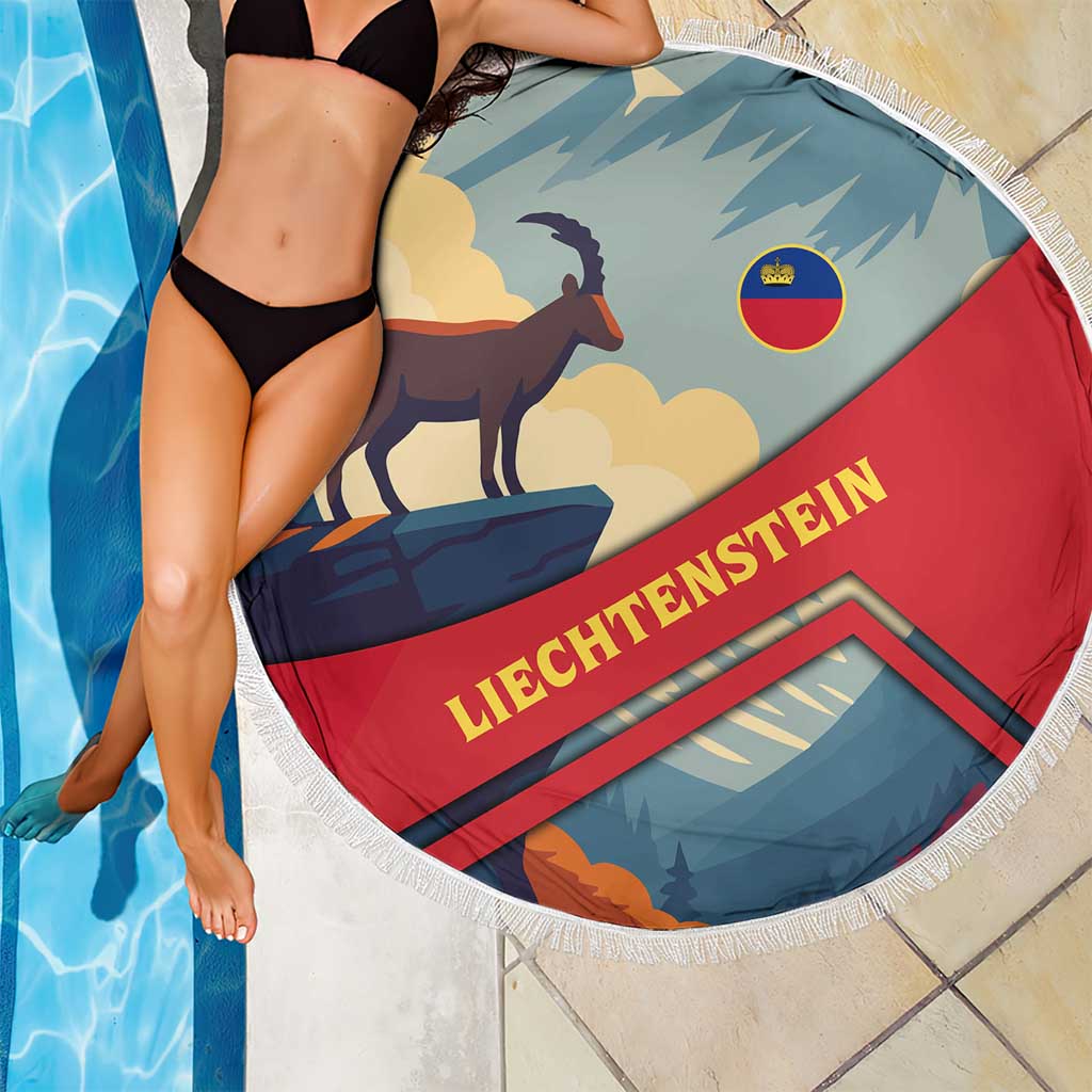 Round fringe beach blanket with goat and cloud mountains graphic, LIECHTENSTEIN text on red