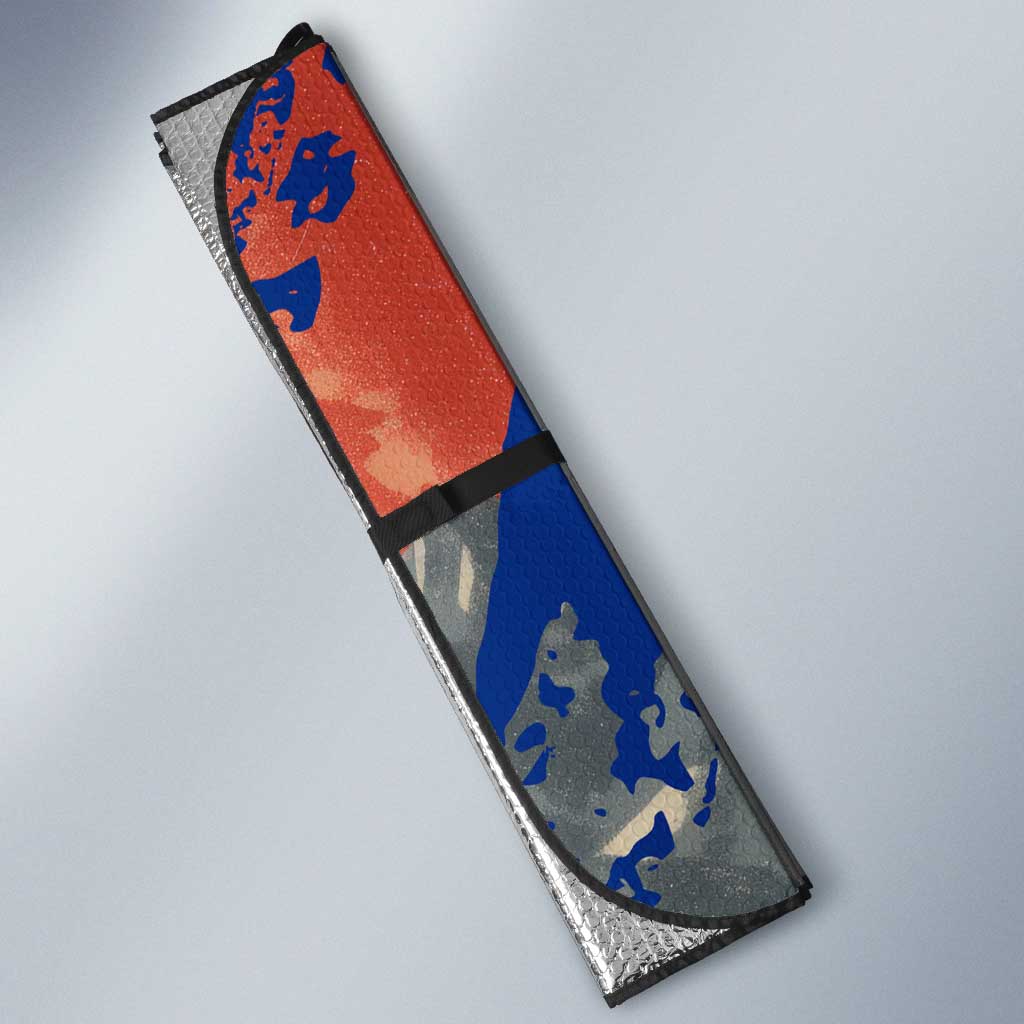 Car sun shade panel, close-up of red and blue alpine ski mountain graphic