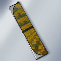 Folded car sun shade with vineyard graphic and black securing straps