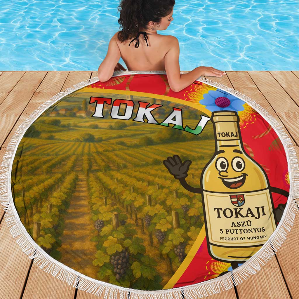 Round beach blanket showing vineyard and Tokaj wine bottle graphic with white fringe