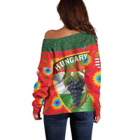Women’s off-shoulder sweater with HUNGARY band and grape cluster graphic, multicolor
