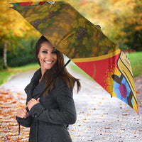 Open multicolor umbrella with Tokaji bottle label and vineyard artwork