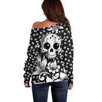 Black off-shoulder sweater with large skull and floral graphic on the back