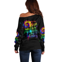 Black off-shoulder sweater with colorful rose smoke skull graphic on back