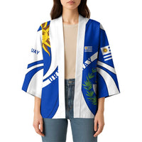 Blue and white kimono on model with draped open front, sun symbol, and emblem print