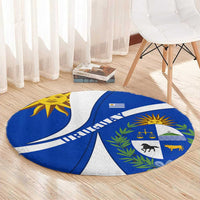 Circular blue-and-white Uruguay emblem rug with sun face and coat-of-arms icons