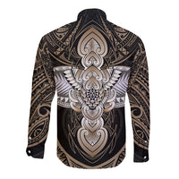 Back of long-sleeve button shirt, dark with large beige winged tribal graphic