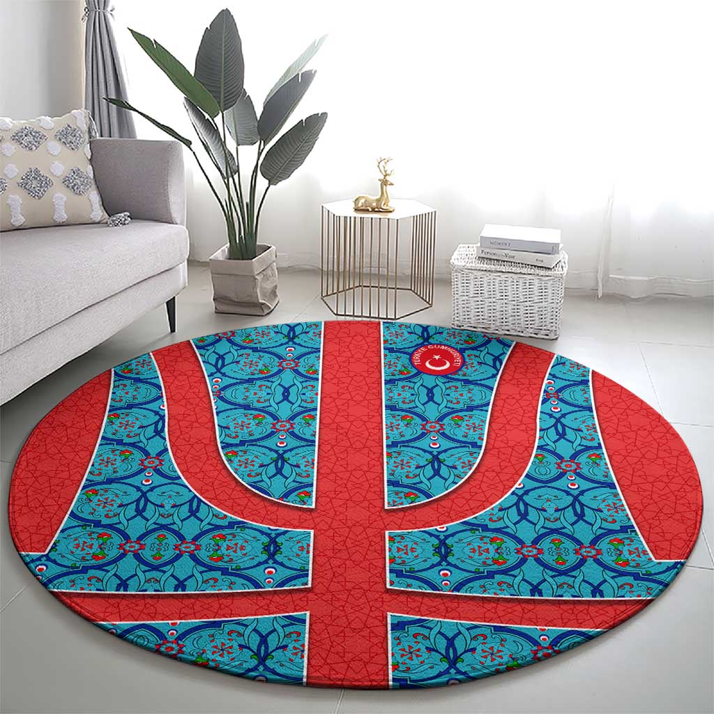 Round Turkish-style blue and red rug with central flag-style emblem and curved motifs