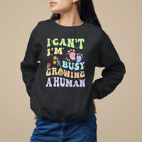 Black pregnancy announcement sweatshirt with “I can't I'm busy growing a human” graphic