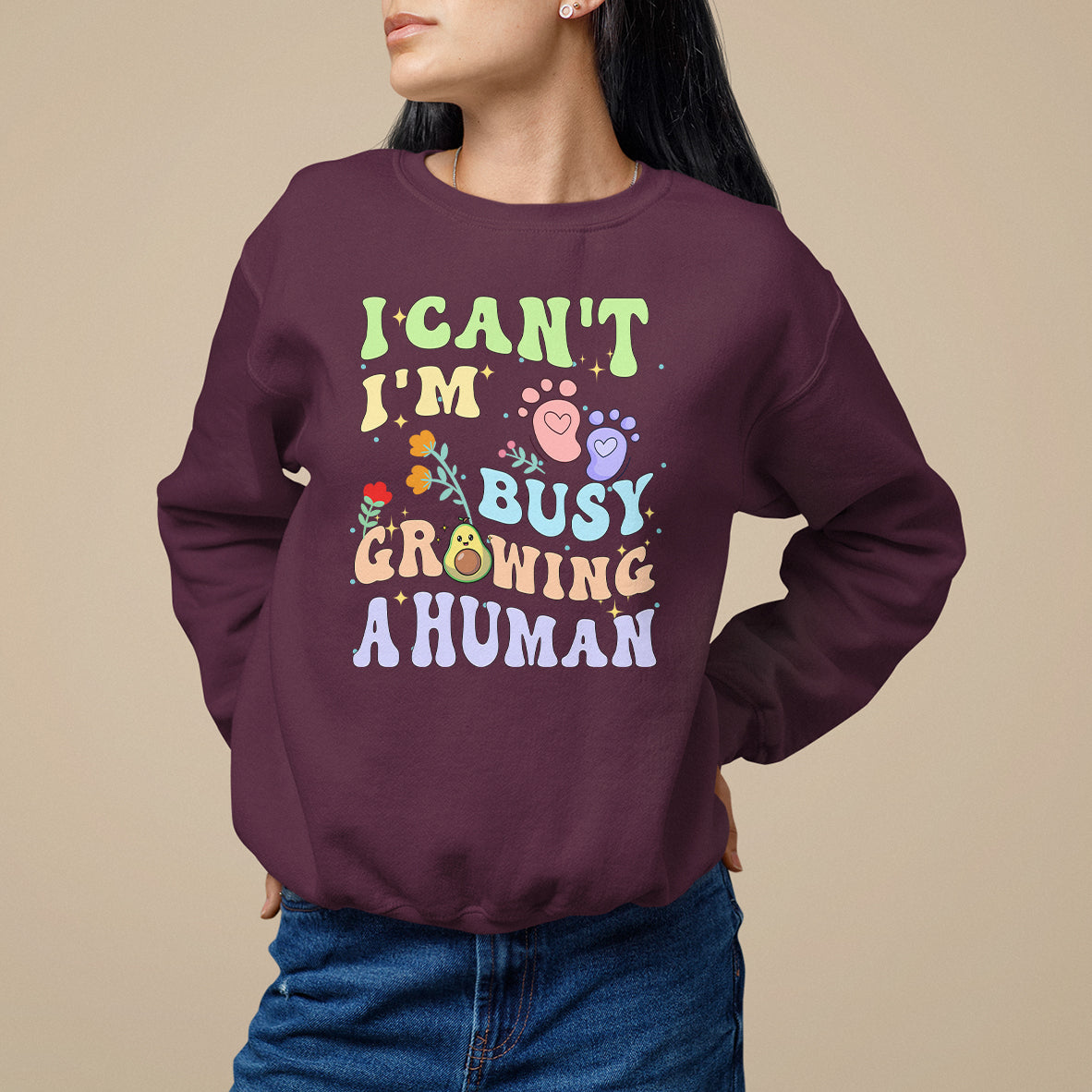 Maroon pregnancy announcement sweatshirt with “I can't I'm busy growing a human” graphic