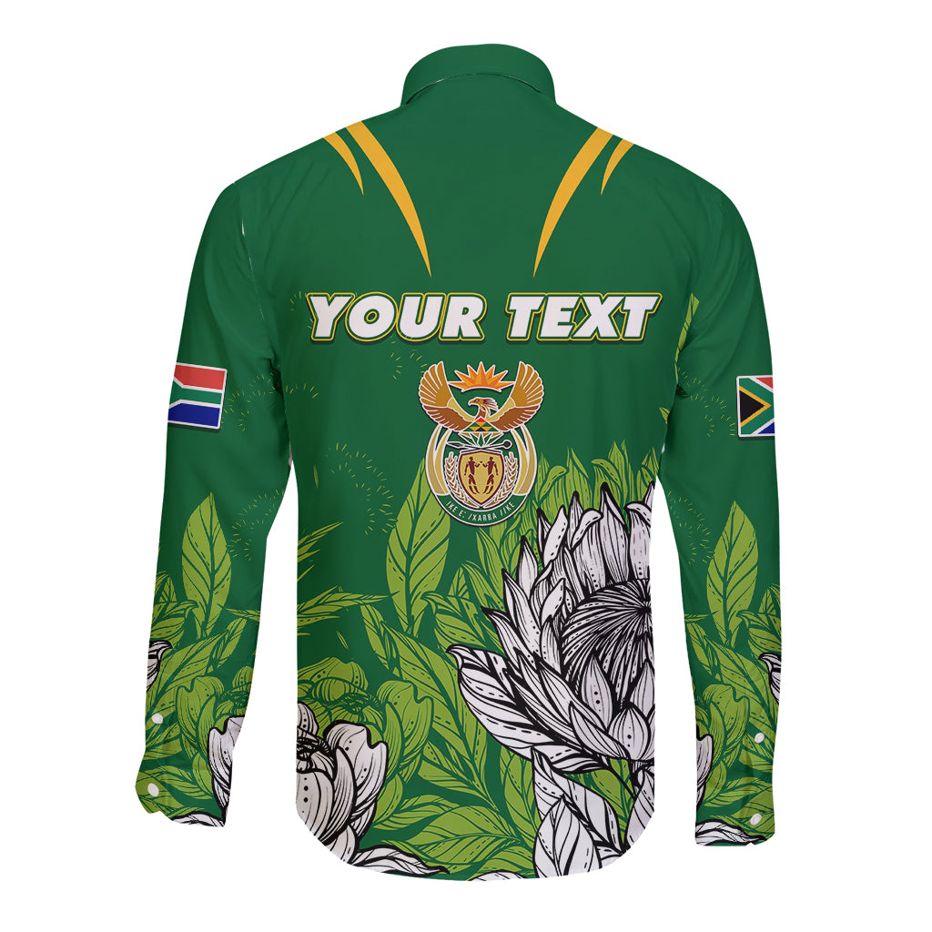 Green long-sleeve button shirt with back crest and “YOUR TEXT”, leaf and protea print