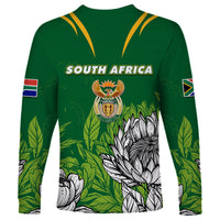 Green long-sleeve jersey with yellow V trim, South Africa text, crest, leaf and protea print