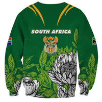 Green unisex sweatshirt with SOUTH AFRICA text, crest logo, and protea print