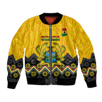 Unisex yellow bomber jacket with kente and adinkra patterns, zip-front and crest graphic
