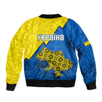 Unisex bomber jacket in yellow and blue, back text UKRAINA with folk map graphic.