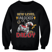 Black crewneck sweatshirt with gamer controller graphic and “New Level Unlocked” text
