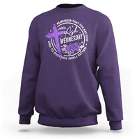 Purple crewneck sweatshirt with purple cross and wreath “Wednesday” graphic