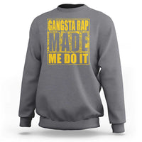 Charcoal gray crewneck sweatshirt with front graphic text 'GANGSTA RAP MADE ME DO IT'.