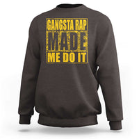 Dark chocolate crewneck sweatshirt with front graphic text 'GANGSTA RAP MADE ME DO IT'.