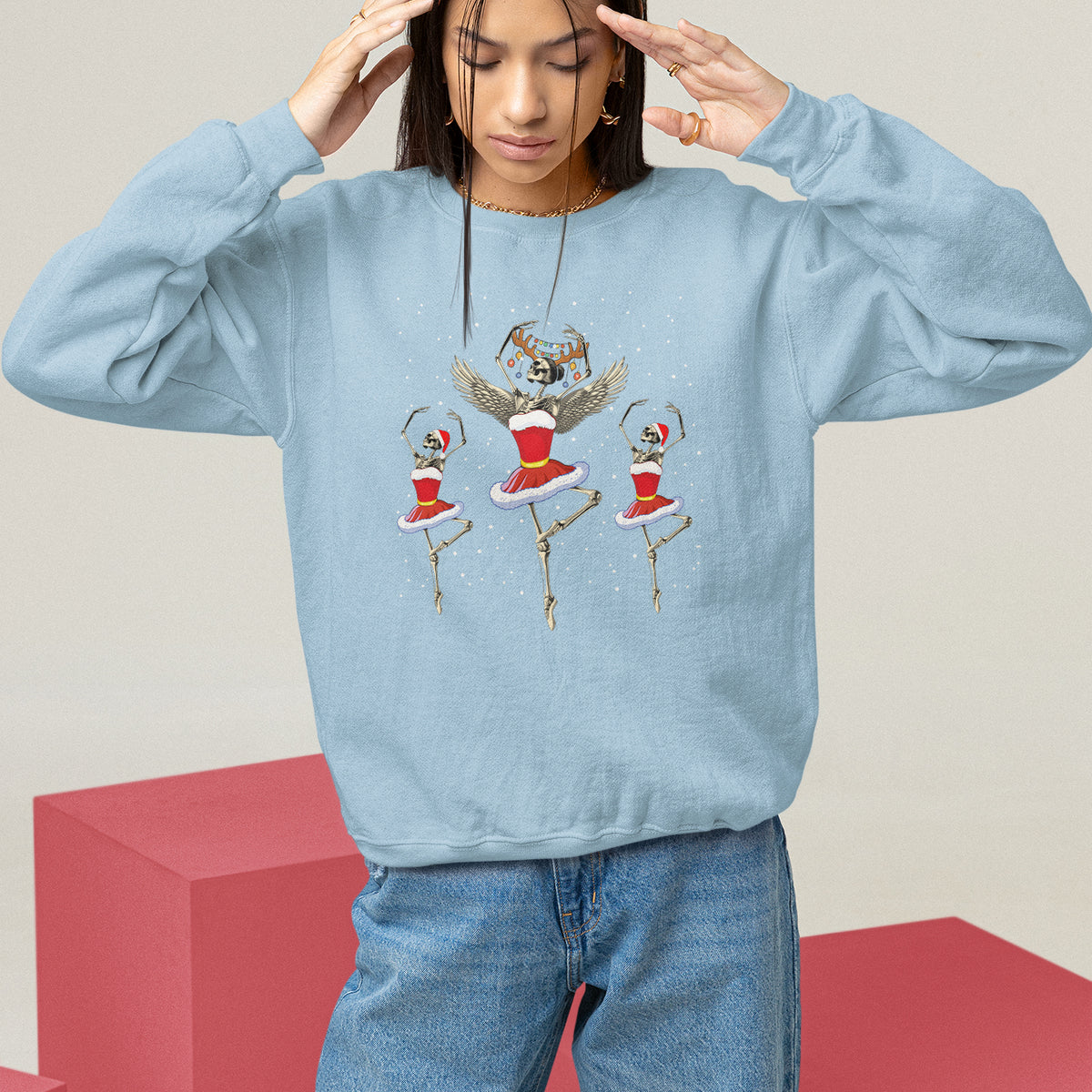 Light blue Christmas sweatshirt with skeleton dancer and ballerina graphic, long sleeves.
